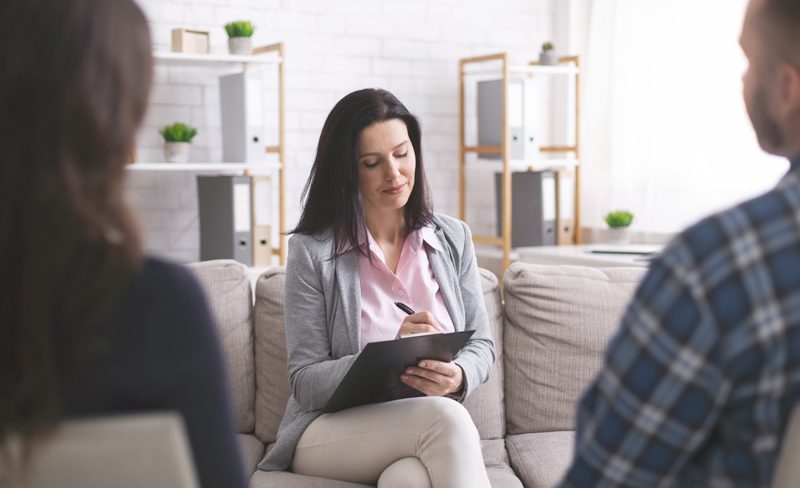 Professional psychologist taking notes at couple meeting with patients Patients Rights